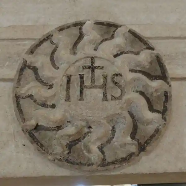 IHS with cross inside a solar disc